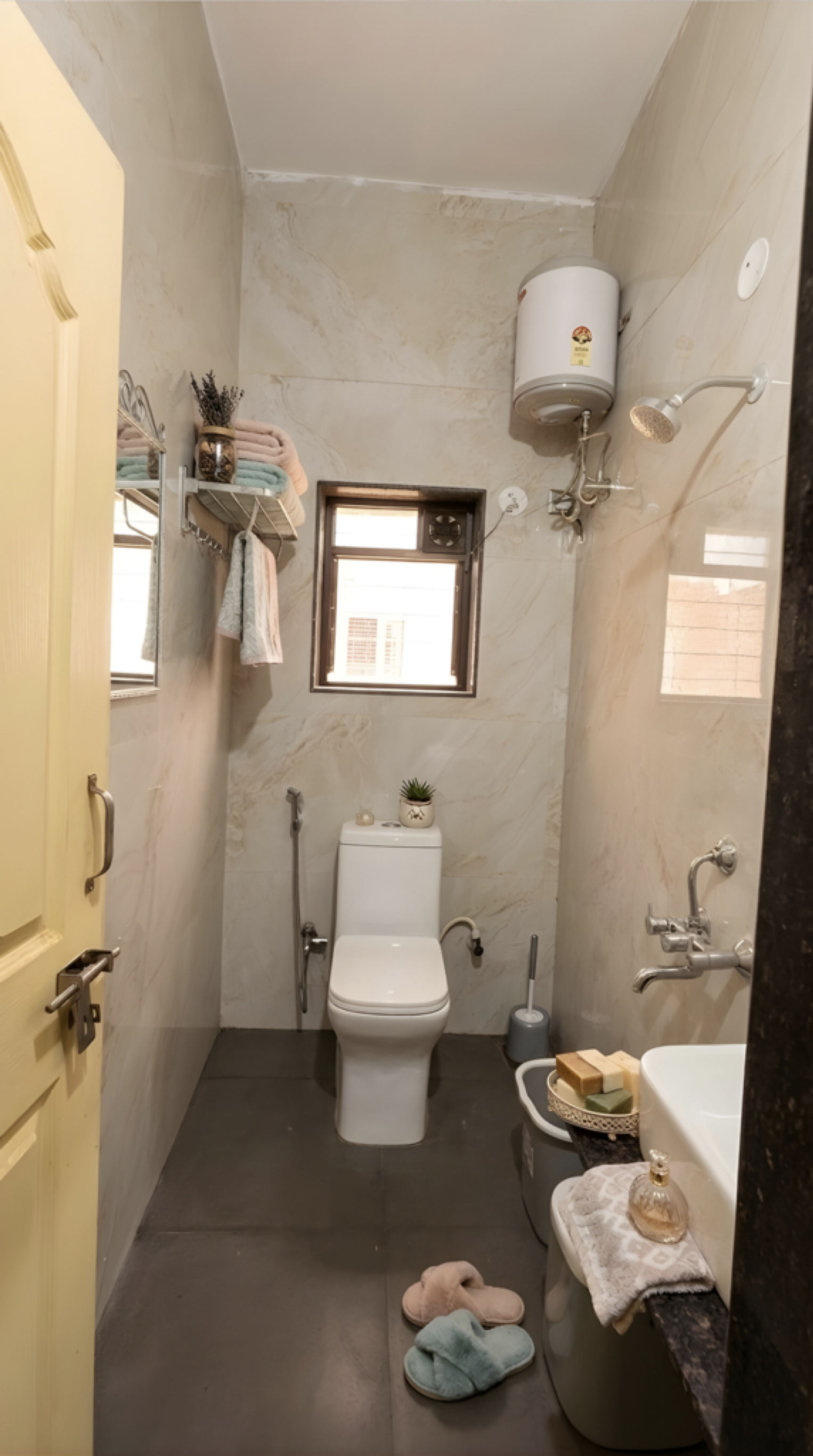 Clean modern bathroom with geyser at D Gloaming Nest girls PG hostel Pune
